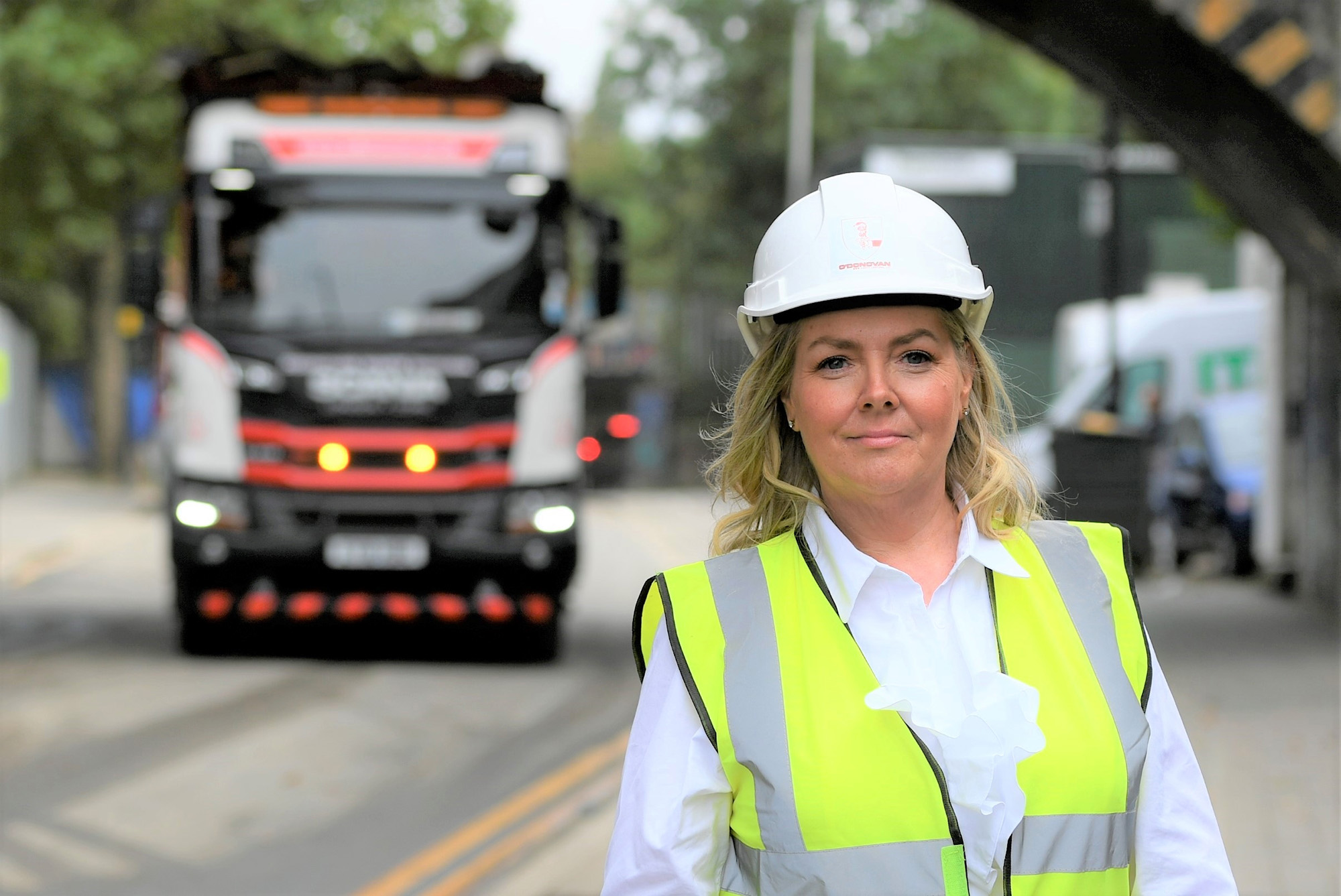 Jacqueline O'Donovan with a helmet on and a waste vehicle behind